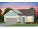 Charming single-story home featuring light blue siding, a two-car garage, and well-manicured landscaping at 2525 Watershed Way, Longs, SC 29568