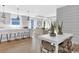 Open-concept living and dining area with modern finishes, wood floors, and ample natural light at 2525 Watershed Way, Longs, SC 29568
