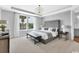 Luxurious main bedroom with a feature wall, large windows, and an elegant chandelier at 2525 Watershed Way, Longs, SC 29568