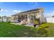 Spacious backyard with a well-maintained lawn, patio area, and shed offering ample outdoor space at 263 Lakota Loop, Longs, SC 29568