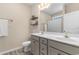 Bathroom with double vanity, linen closet, and neutral color palette at 263 Lakota Loop, Longs, SC 29568