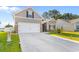Well-maintained home displaying a spacious driveway, neat lawn, and a two-car garage at 263 Lakota Loop, Longs, SC 29568