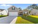 Charming home featuring a two-car garage, beautiful lawn, and classic curb appeal on a sunny day at 263 Lakota Loop, Longs, SC 29568