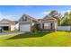 Attractive home showcasing manicured lawn, gray siding, brick accents, and a two-car garage at 263 Lakota Loop, Longs, SC 29568