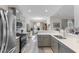 Bright kitchen showcasing stainless steel appliances, quartz counters, and open layout to dining area at 263 Lakota Loop, Longs, SC 29568