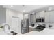 Modern kitchen features stainless steel appliances, light gray cabinets, and white countertops at 263 Lakota Loop, Longs, SC 29568