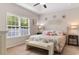 Bright primary bedroom featuring tray ceiling, beach themed decor and lots of natural light at 263 Lakota Loop, Longs, SC 29568