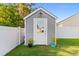 Exterior of backyard shed with gray siding, white trim, and a secure door, offering extra storage at 263 Lakota Loop, Longs, SC 29568