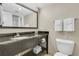 Bathroom featuring a granite countertop, well-lit mirror, and towel racks at 2710 N Ocean Blvd. # 804, Myrtle Beach, SC 29577