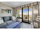 Comfortable living room with sofa, ottoman, and balcony access with seating at 2710 N Ocean Blvd. # 804, Myrtle Beach, SC 29577