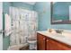 Traditional bathroom with a vanity, toilet, mirror, and shower with a curtain at 2940 Tigers Eye Rd., Little River, SC 29566