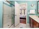 Bright bathroom with a walk-in shower, vanity, and a view to the main bedroom at 2940 Tigers Eye Rd., Little River, SC 29566