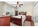 Cozy bedroom featuring hardwood floors, ceiling fan, and natural light at 2940 Tigers Eye Rd., Little River, SC 29566