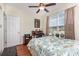 This comfortable bedroom features a desk, a ceiling fan, and a view of the neighborhood at 2940 Tigers Eye Rd., Little River, SC 29566