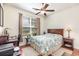 Well-lit bedroom with a desk area, ceiling fan, and a comfy bed at 2940 Tigers Eye Rd., Little River, SC 29566