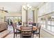 Bright dining area features a round table, tile flooring, and a large window overlooking the pool area at 2940 Tigers Eye Rd., Little River, SC 29566