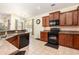 Open-concept kitchen featuring wood cabinets and tile flooring at 2940 Tigers Eye Rd., Little River, SC 29566