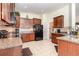 Kitchen featuring wood cabinets, granite countertops, and tile flooring at 2940 Tigers Eye Rd., Little River, SC 29566