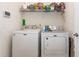 Bright laundry room with a full size washer, dryer, and wire shelving for ample storage at 2940 Tigers Eye Rd., Little River, SC 29566
