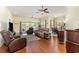 Open concept living room featuring hardwood floors, ceiling fans, and lake views at 2940 Tigers Eye Rd., Little River, SC 29566
