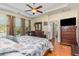 Spacious main bedroom with hardwood floors, a ceiling fan, and an ensuite bathroom at 2940 Tigers Eye Rd., Little River, SC 29566
