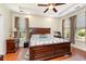 This spacious main bedroom features tray ceilings, hardwood floors, and ample natural light from multiple windows at 2940 Tigers Eye Rd., Little River, SC 29566
