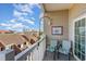 Relaxing balcony with seating area and views of neighboring rooftops and distant buildings at 311 2Nd Ave. N # 210, North Myrtle Beach, SC 29582