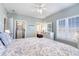 Bright bedroom with a large window, dresser, and an organized walk-in closet at 311 2Nd Ave. N # 210, North Myrtle Beach, SC 29582