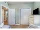 Bedroom featuring twin beds, a TV, and closet, offering a comfortable and functional space at 311 2Nd Ave. N # 210, North Myrtle Beach, SC 29582