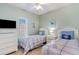 Well-lit bedroom with twin beds, matching nightstands, and a dresser beneath a window at 311 2Nd Ave. N # 210, North Myrtle Beach, SC 29582