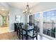 Elegant dining area with a modern chandelier and balcony access at 311 2Nd Ave. N # 210, North Myrtle Beach, SC 29582