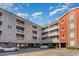 Condo building featuring multiple balconies, covered parking, and well-maintained landscaping at 311 2Nd Ave. N # 210, North Myrtle Beach, SC 29582