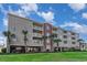 Multi-story condo building with ample balconies, garage parking, and lush, vibrant landscaping at 311 2Nd Ave. N # 210, North Myrtle Beach, SC 29582