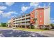 Beautiful condominium exterior with multiple balconies, lovely landscaping and street view at 311 2Nd Ave. N # 210, North Myrtle Beach, SC 29582
