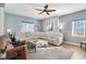 Spacious living room with modern ceiling fan, plush seating, and natural light at 311 2Nd Ave. N # 210, North Myrtle Beach, SC 29582
