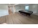 Spacious basement showcasing a pool table, light wood flooring, and white storage cabinets at 326 15Th Ave. S, Surfside Beach, SC 29575