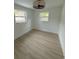Cozy bedroom featuring light wood flooring, two windows, and a ceiling fan at 326 15Th Ave. S, Surfside Beach, SC 29575