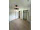 Bedroom featuring a closet, light wood floors, white walls, and a modern ceiling fan and light fixture at 326 15Th Ave. S, Surfside Beach, SC 29575