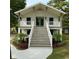 Charming two-story home featuring a lovely stairway, elevated porch, and beautifully landscaped front yard at 326 15Th Ave. S, Surfside Beach, SC 29575