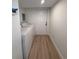 Compact laundry area including a washer and dryer, located just off of the garage at 326 15Th Ave. S, Surfside Beach, SC 29575