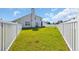 Backyard featuring a lush lawn, white picket fence, outdoor furniture, and a view of the home's exterior at 381 Winslow Ave., Myrtle Beach, SC 29588