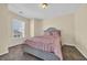 Comfortable bedroom with a light grey bed frame, plush carpet, and ample natural light at 381 Winslow Ave., Myrtle Beach, SC 29588