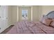 Cozy bedroom features a plush pink comforter on a grey bed frame and natural light from the window at 381 Winslow Ave., Myrtle Beach, SC 29588