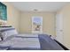 A bright bedroom featuring a light blue comforter, natural light, and neutral walls at 381 Winslow Ave., Myrtle Beach, SC 29588