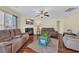 Cozy living room with a fireplace, ceiling fan and comfortable seating, perfect for relaxing and entertaining at 381 Winslow Ave., Myrtle Beach, SC 29588