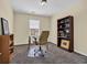 This home office features natural light, carpet, and a stylish desk and bookshelf at 381 Winslow Ave., Myrtle Beach, SC 29588