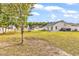 A large grassy backyard with a white fence, patio, mature trees and plenty of space for outdoor activities at 4008 Scarlet Oak Ct., Myrtle Beach, SC 29579