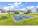 Community basketball court surrounded by lush green grass and neighborhood homes at 4008 Scarlet Oak Ct., Myrtle Beach, SC 29579