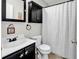 Well-lit bathroom featuring a stylish black vanity, matching medicine cabinet, and a shower with a modern curtain at 4008 Scarlet Oak Ct., Myrtle Beach, SC 29579