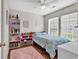 Bright bedroom featuring a ceiling fan, a pink rug, and large windows that let in plenty of natural light at 4008 Scarlet Oak Ct., Myrtle Beach, SC 29579